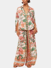 Pantalones anchos con puños con abertura y estampado floral único